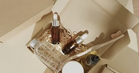 Close up of cardboard boxes with glass bottles, cream tub and toothbrush on Stock Footage 331246054