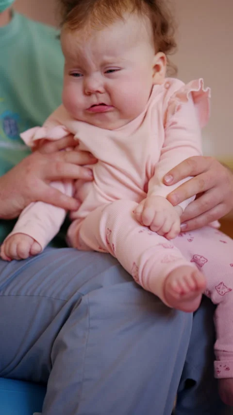 Close up of a caregiver lifting and supporting an infant during mobility Stock Footage 336927767