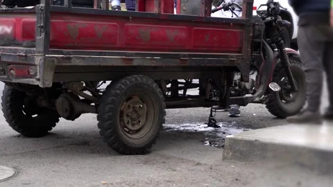 Close-up of a cargo motorcycle leaking gasoline from mechanical failure and fire Stock Footage 161198053