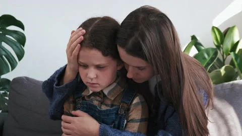 Close up of caring young mother hugging, calming upset little daughter Stock Footage 220647000