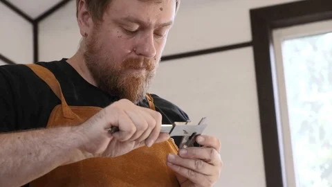 Close-up. A carpenter with a caliper makes measurements. A man works with a tree Stock Footage 113996434