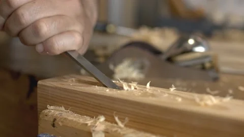 Close up of a Carpenter carving wood using a chisel Video stock 153109970