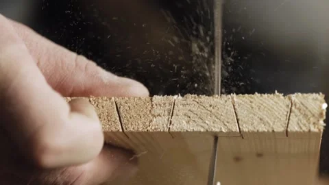 Close up. carpenter cuts out a dovetail on a wood board with a hand saw. hand Видео 166340997