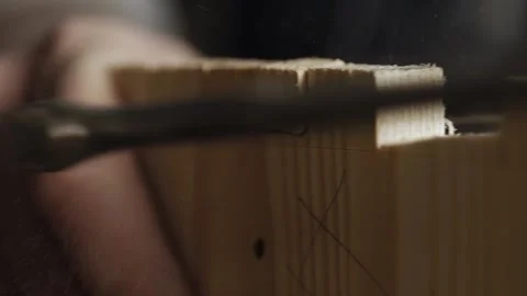Close up. a carpenter cuts out a dovetail on a wooden board with a hand jigsa Stock Footage 166341009