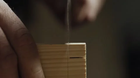 Close up. a carpenter cuts out a dovetail on a pine board with a hand saw. wo Stock Footage 166341045