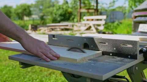 Close Up of Carpenter Cutting Wood with Table Saw Stock Footage 343598915