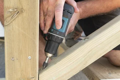 Close up of a carpenter with drilling machine construction tool Stock Photos