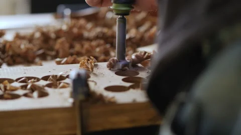 Close-up. a carpenter drills a walnut board with a milling cutter for wood. w Stock Footage 144243816