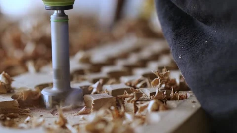 Close-up. a carpenter drills a walnut board with a milling cutter for wood. v Stock Footage 144243832