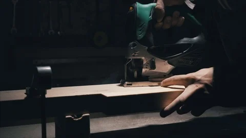 Close-up, carpenter holds the workpiece, using a jigsaw the worker cuts a piece  스톡 동영상 78438264