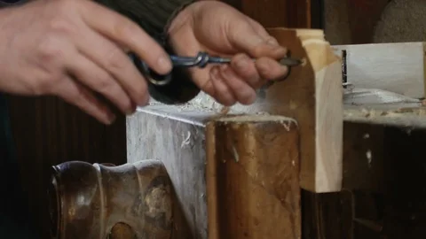 Close up, carpenter makes a hole by using tip turning loving Stock Footage 97457833
