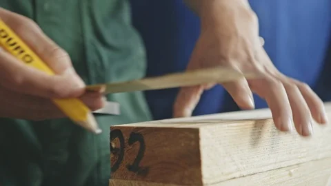 Close up of carpenter marking length of timber Stock Footage 100610326