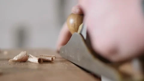 Close-up. a carpenter planes a small wooden board with a hand plane Stock Footage 156683473