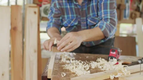 Close up carpenter planning to smooth the face of wood Stock Footage 173694357