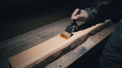 Close-up, Carpenter putting the first layer of protective coating oil on the wor 스톡 동영상 78437784