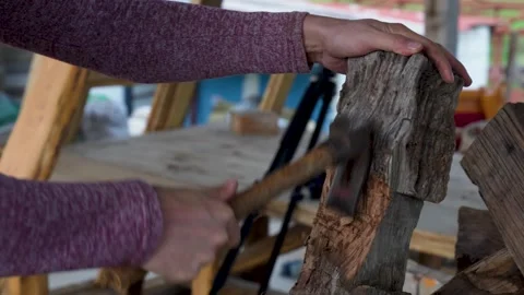 Close up of carpenter splitting antique chestnut wood with an axe Stock Footage 325204249