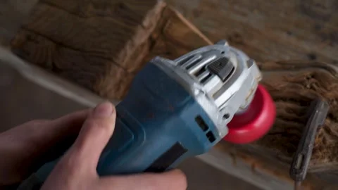 Close up of a carpenter using an angle grinder on wood Stock Footage 325206578