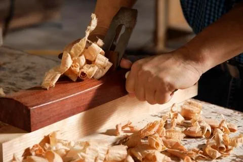 Close up of a carpenter using a block plane. Stock Photos