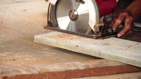 Close-up of a carpenter using a circular saw to cut a board to repair a house. 스톡 동영상 169438936