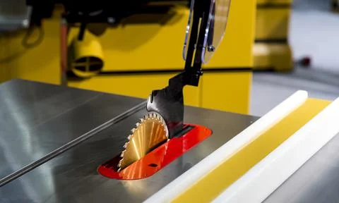 Close-up of a carpenter using a circular saw to cut a large board of wood Stock Photos