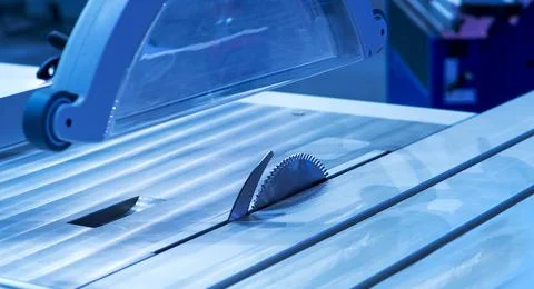Close-up of a carpenter using a circular saw to cut a large board of wood Stock Photos