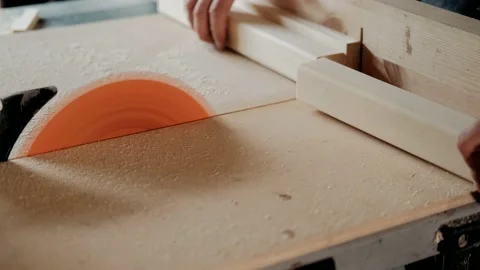 Close up of carpenter worker using saw cutting wooden plank on construction site Stock-Footage 140281896