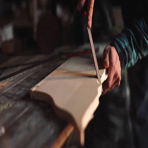 Close-up of a Carpenter working on a Wooden Window Frame with a File in his Stock Footage 69540563