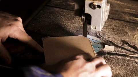 Close-up of carpenter's hand working on band saw cuts corners Stock Footage 100760902