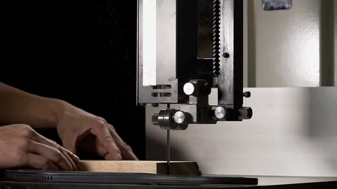 Close-up of carpenters hand working on electric band saw. Stock Footage