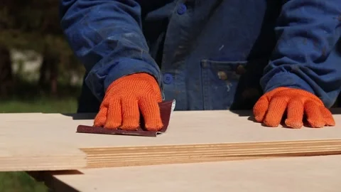 Close-up of a carpenter's hands processing plywood Stock Footage 336807526