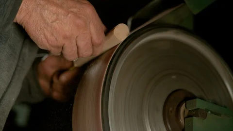 CLOSE UP: Carpentry apprentice making a wooden handle out of a piece of wood. Video stock 110876392
