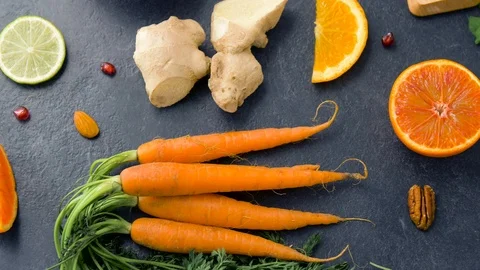 Close up of carrot, ginger, orange, lemon and nuts Stock Footage 88623954