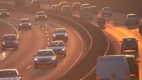 CLOSE UP: Cars driving slowly on busy jammed road during the evening rush hour Stock Footage