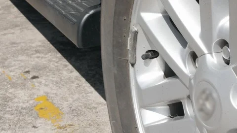 Close up to car's tire while driver inflating car tire in sunny daytime. Ha.. Stock Footage 281833831