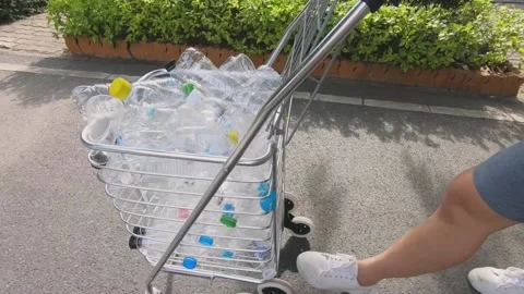 Close up cart full of plastic bottles going to recycle with sunlight Stock Footage 137142667