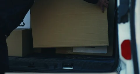Close up of the carton box parcel being taken out from the delivering white van Stock Footage 99236574