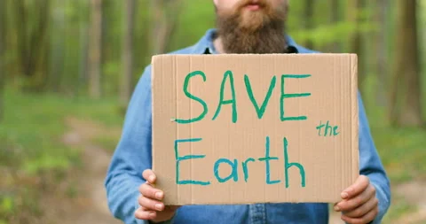 Close up of carton poster with words Save the Earth in hands of Caucasian man Stock Footage 130486304