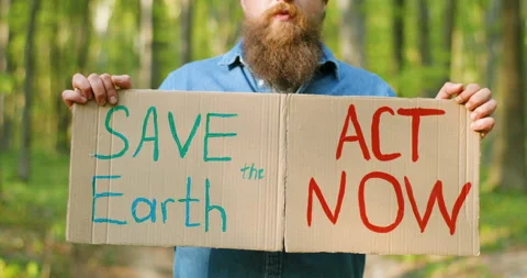 Close up of carton posters with words Save the Earth and Act Now in hands of Stock Footage 130486448