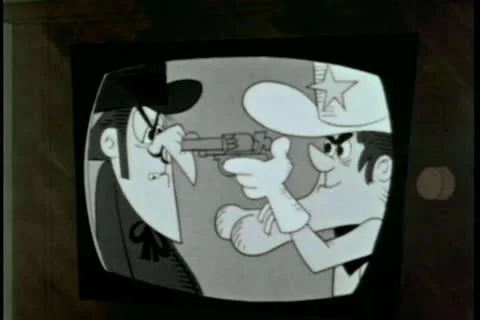 Close-up cartoon playing on television set Stock Footage