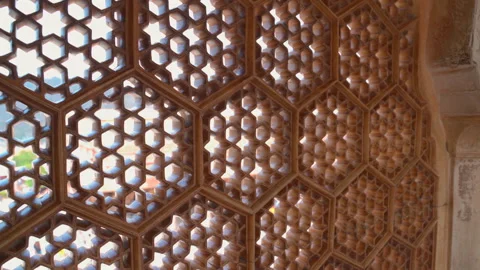 Close up of carved stone lattice window jaali with hexagonal pattern at Amer Stock Footage 345394372