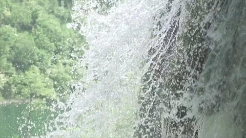 Close-up of cascading water hitting mossy rocks at Plitvice Stock Footage 319783377