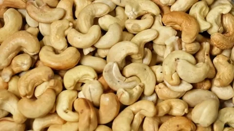 Close up of cashew nuts pattern texture. Overhead view of cashew nuts rotating Video stock 220725670