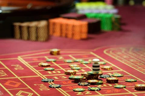 Close-up of casino chips on the red table Stock Photos