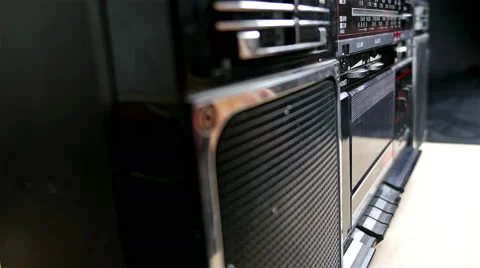 Close up to a cassette tape deck when fingers put a cassette and start playing Stock Footage 57542920