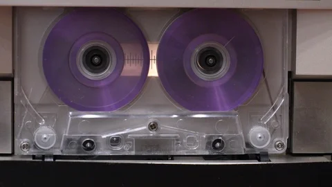 Close-up of cassette tape playing rewinding and stopping at various speeds Stock Footage 89961122