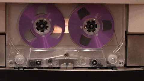 Close-up of cassette tape rolling while in stereo cassette player Stock Footage 89920694