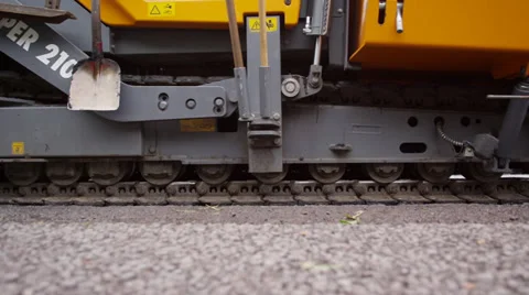 Close up of caterpillars of an asphalt machine in operation Видео 37433696