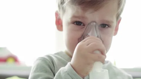Close up Caucasian 3-4 years minor preschool boy kid in the mask of an inhaler Stock Footage 148964344