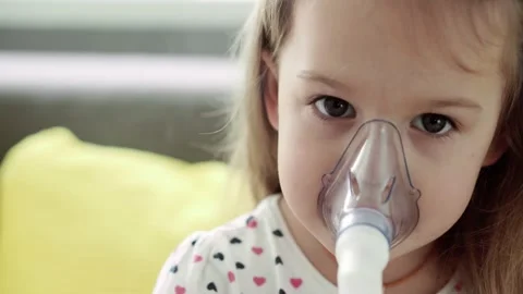Close up Caucasian 3-4 years minor preschool girl kid in the mask of an inhaler Stock Footage 149012587