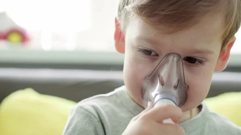 Close up Caucasian 3-4 years minor preschool boy kid in the mask of an inhaler Stock Footage 149079893
